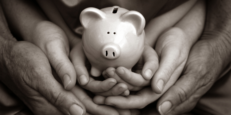 a family of 3 holding a piggy bank