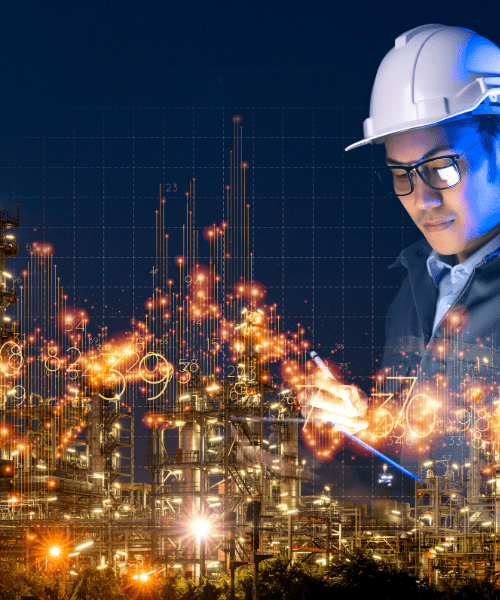 A man in a white hard hat looking at oil equipment and data