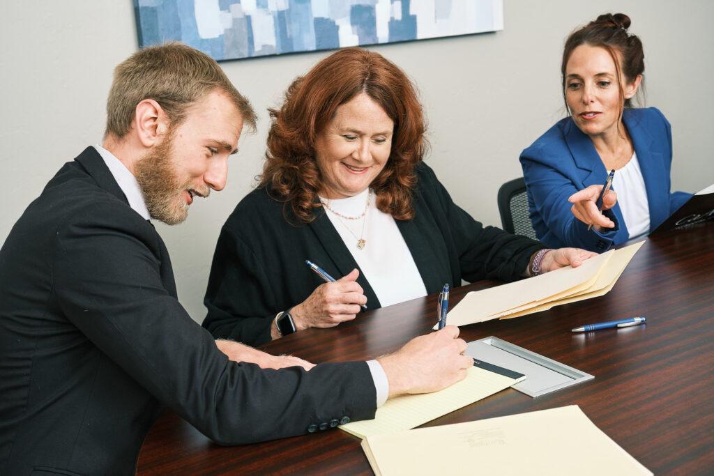 Vertices accounting owner reviewing a tablet at a wooden desk