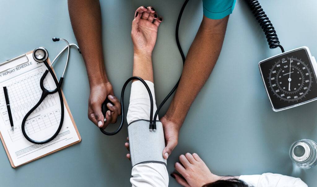 A nurse taking someone's blood pressure