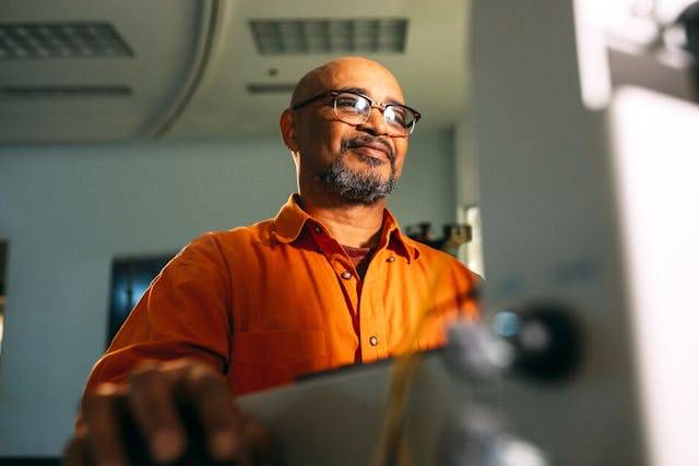 A man smiling at his laptop