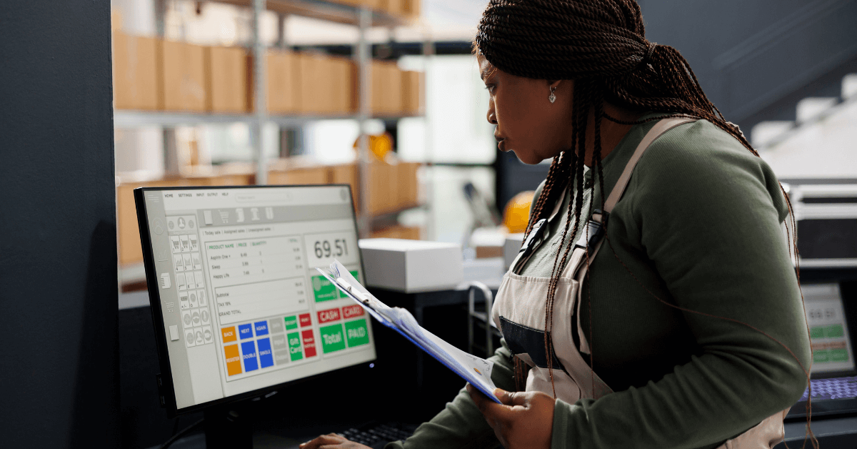 Warehouse owner reviewing computer screen with labor cost calculator