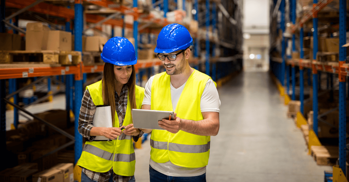 Warehouse workers reviewing labor cost documents